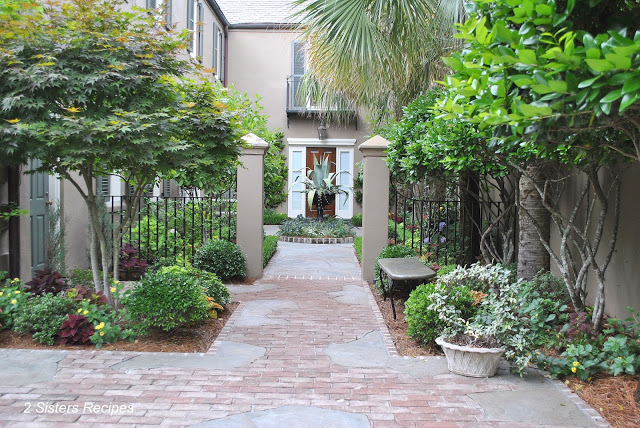 A view of a pathway to a home and garden of Charleston, SC