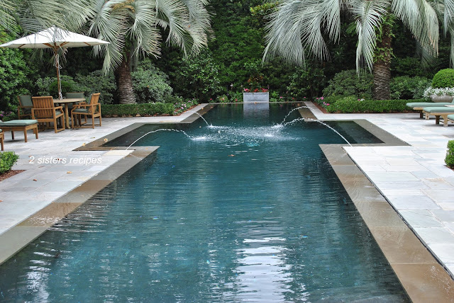 A large Gunite pool with jet fountains in the pool. 