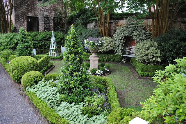 A view of a intimate garden beautifully landscape with small trees.