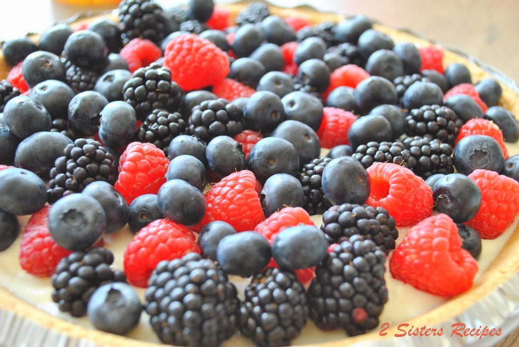 A pie with mixed berries covering the top. 