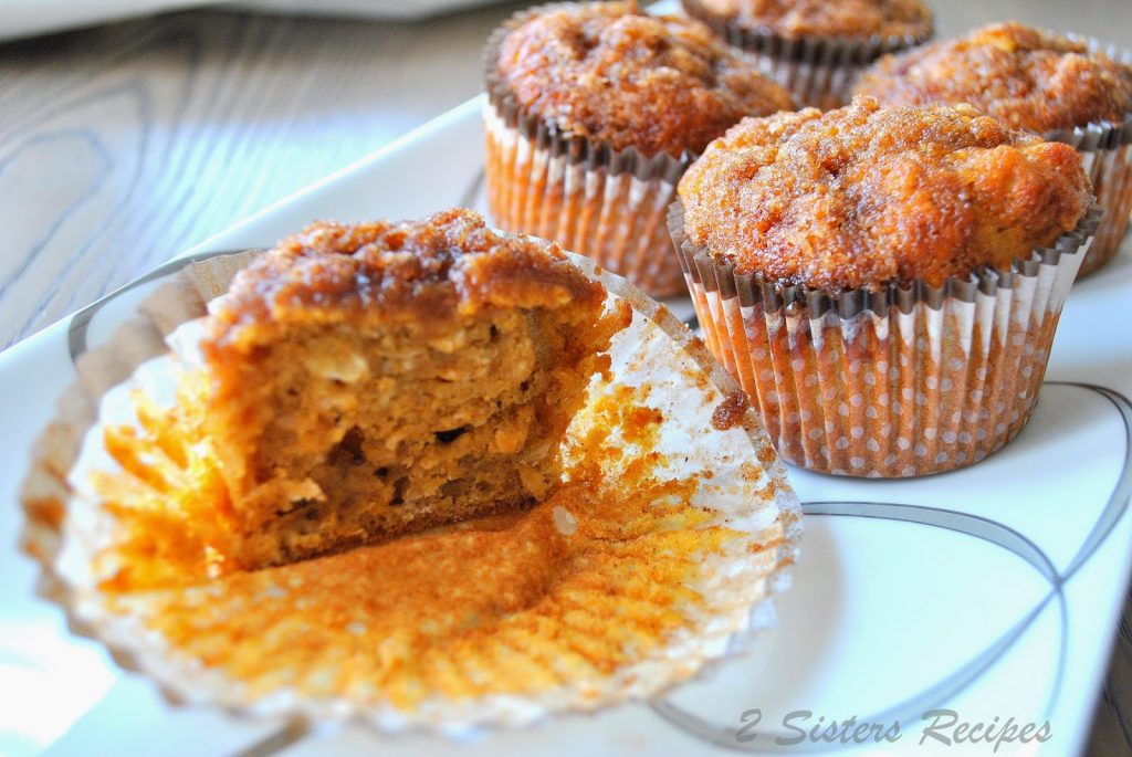 Cinnamon sweet potato muffin cut in halve on a serving platter. by 2sistersrecipes.com