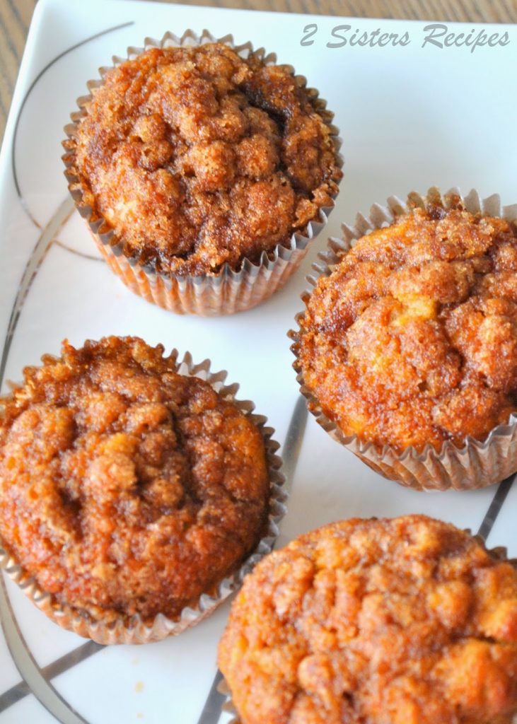 A white and silver platter with baked muffins.  by 2sistersrecipes.com