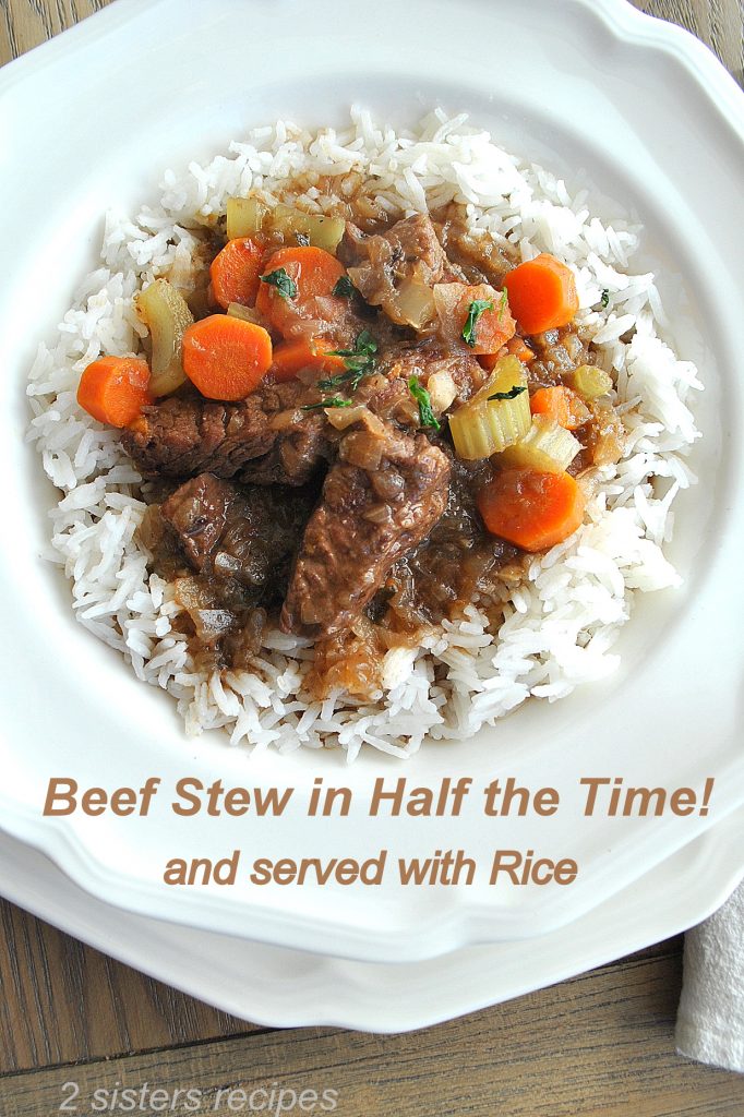 A white dinner plate with cooked rice and some beef and vegetables on top. 2sistersrecipes.com