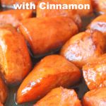 A large sheet pan filled with sweet potatoes roasted with honey and cinnamon glaze.