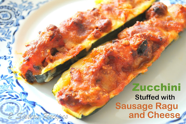 2 zucchini boats baked on a white and blue plate.