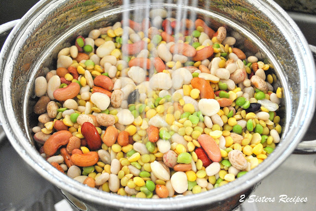  pot of dried mixed, and colorful beans under running water, rinsing. 