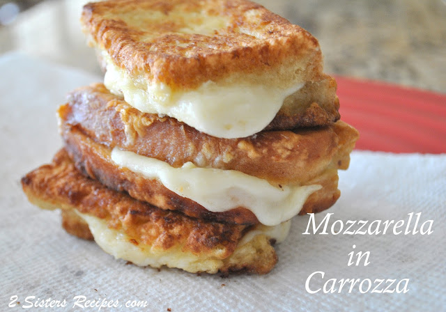 3 mini fried Mozzarella in Carrozza sandwiches piled on top of each other on a white sheet paper towel. by 2sistersrecipes.com 