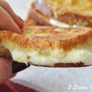 Holding the Italian fried cheese sandwich. by 2sistersrecipes.com