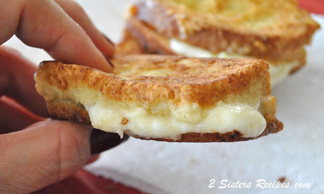 Holding the Italian fried cheese sandwich. by 2sistersrecipes.com 