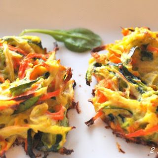 on a white platter is a serving of baked vegetable bird's nests