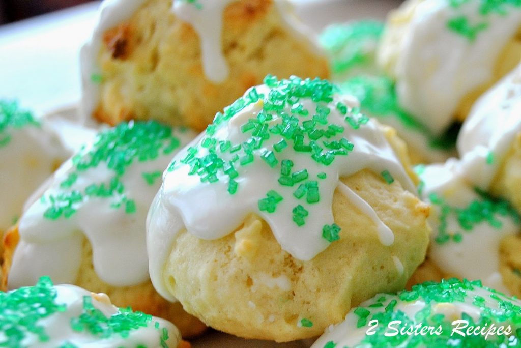 Italian Lemon Cookies with icing and green sprinkles on top.