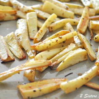 A baking pan filled with cut parsnips shaped like fries, and baked them with herbs.