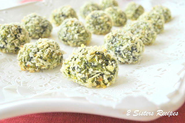 A white platter filled with little spinach and kale balls. by 2sistersrecipes.com