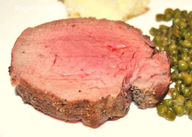 a perfectly cooked slice of filet mignon on a dinner plate. by 2sistersrecipes.com