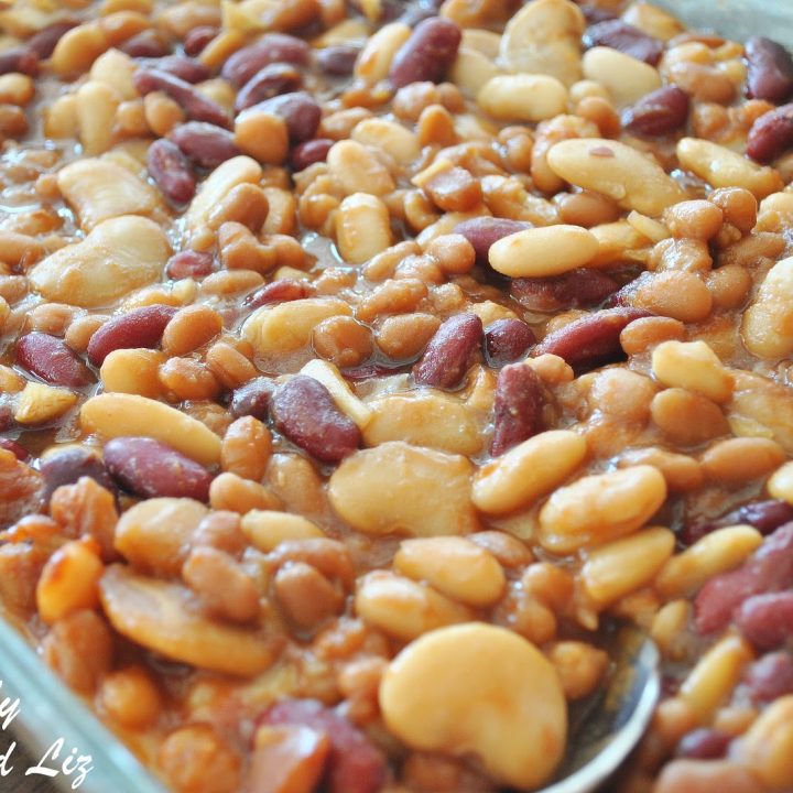 A large glass baking dish filled with baked beans of all sizes.