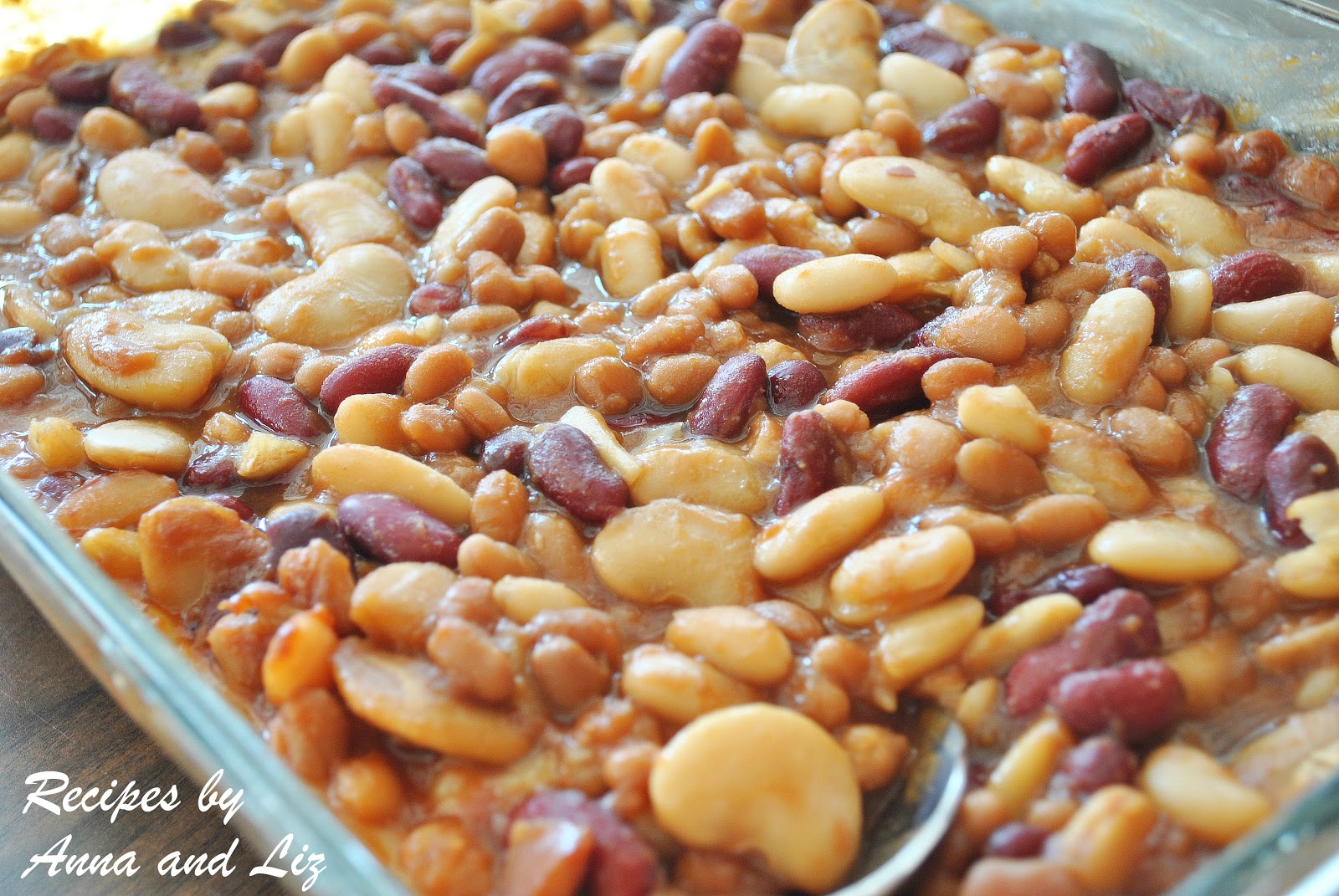 A large glass baking dish filled with baked beans of all sizes.