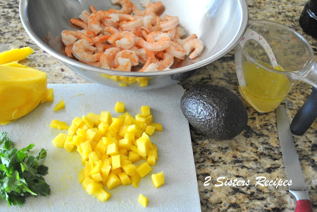 Chopped mango on a cutting board, on the counter. by 2sistersrecipes.com