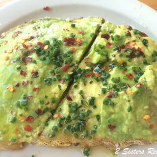 one avocado toast served on a white plate.