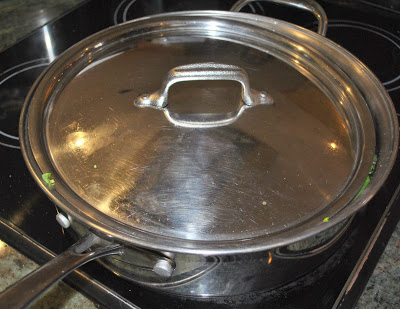 A cover is placed onto the large skillet.