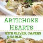An oval white platter filled with artichoke hearts with olives. capers and parsley.