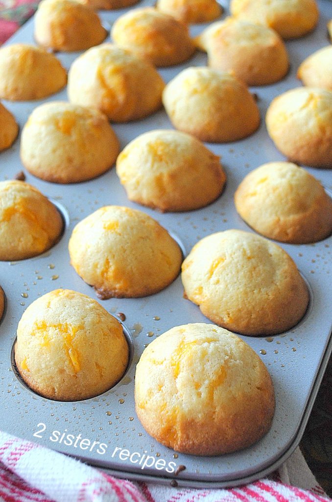 A mini muffin pan filled with already baked biscuits. by 2sistersrecipes.com
