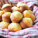 Cheesy Mini Biscuits in a basket with checker cloth.