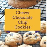A bunch of chocolate chip cookies resting on a wire rack.