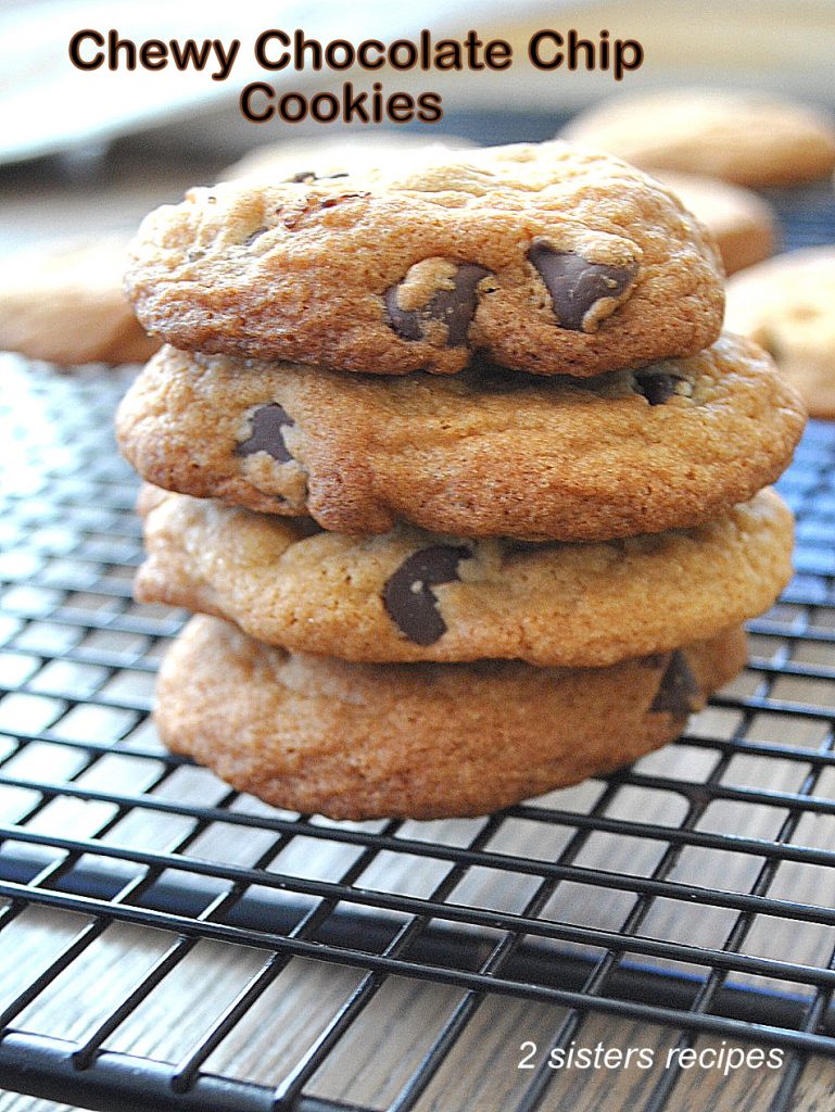A pile of chocolate chip cookies on a wire rack.