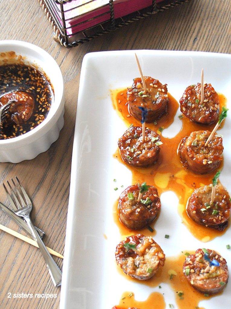 A plate with some sausage bites with toothpicks by 2sistersrecipes.com 