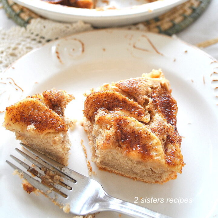 A slice of coffee cake served on a plate with a fork.