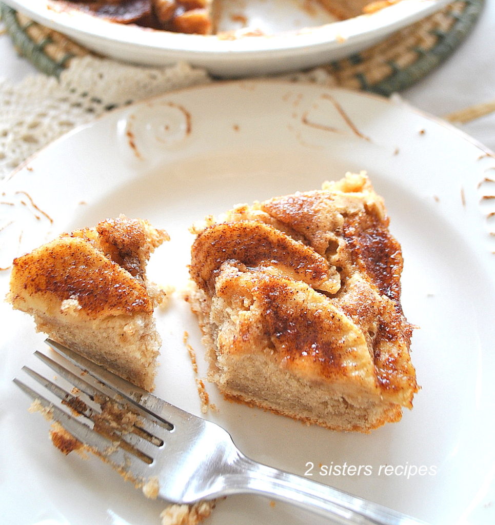 A slice of coffee cake served on a plate with a fork.