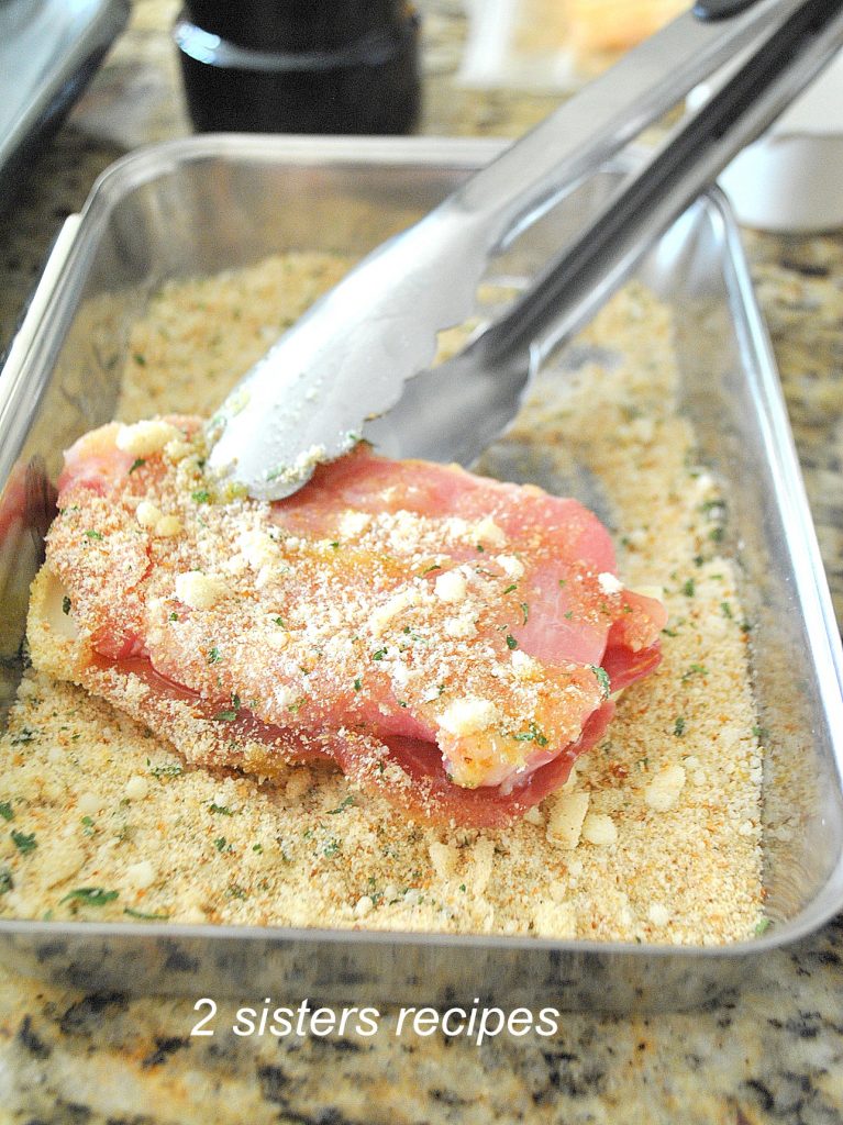 Pork chop is coated in a bread crumb mixture.  by 2sistersrecipes.com