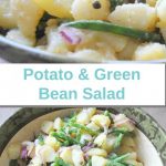 A large salad bowl filled with chunks of potatoes, green beans and sliced red onions.