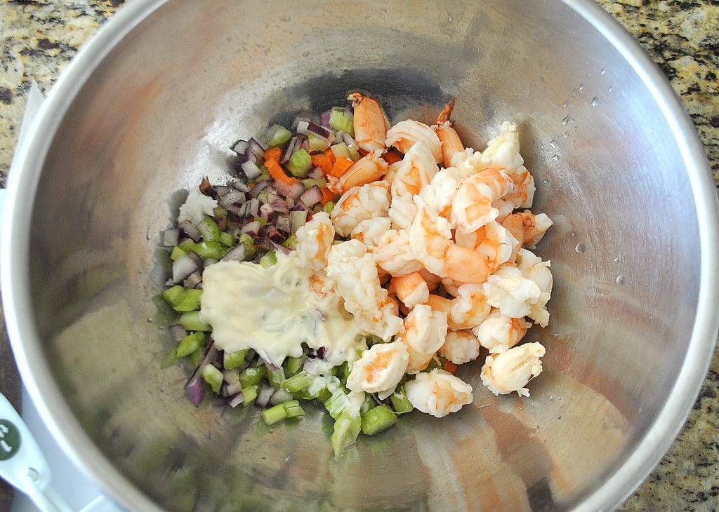 A silver mixing bowl with the chopped ingredients. 