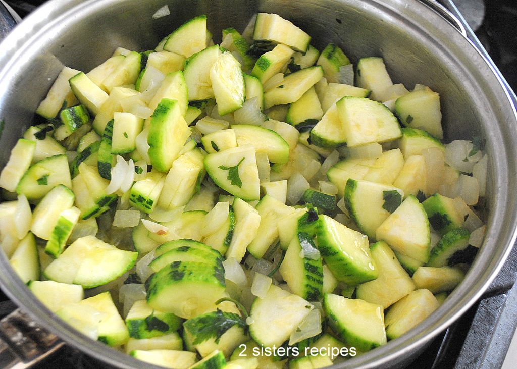 Zucchini cooking in a large skillet by 2sistersrecipes.com 