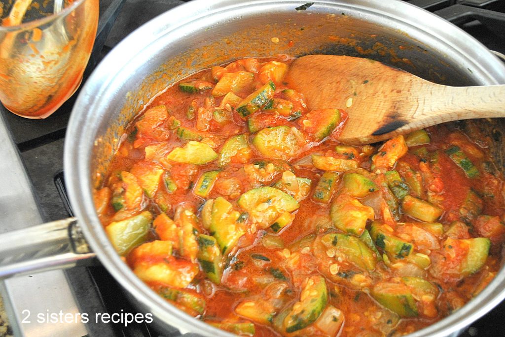 Marinara sauce is poured into the pan with zucchini mixture,  by 2sistersrecipes.com