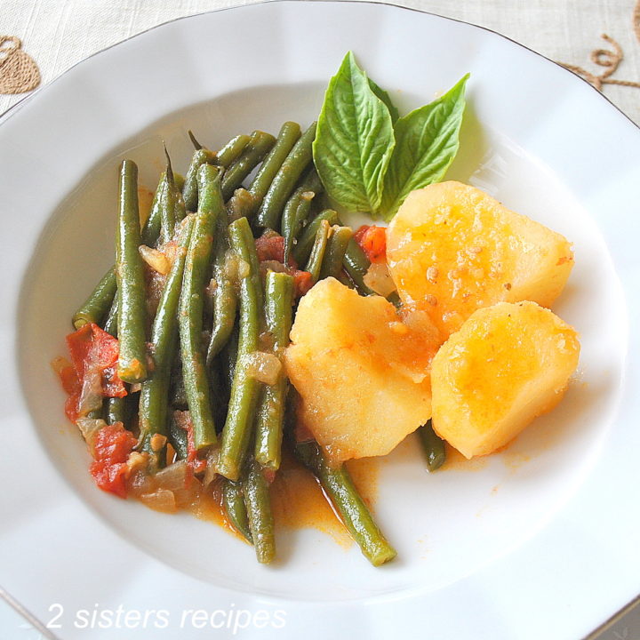 String Beans Tomato Potato Stew served in a white plate.