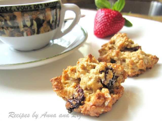 Two cookies set on the table next to an espresso cup.