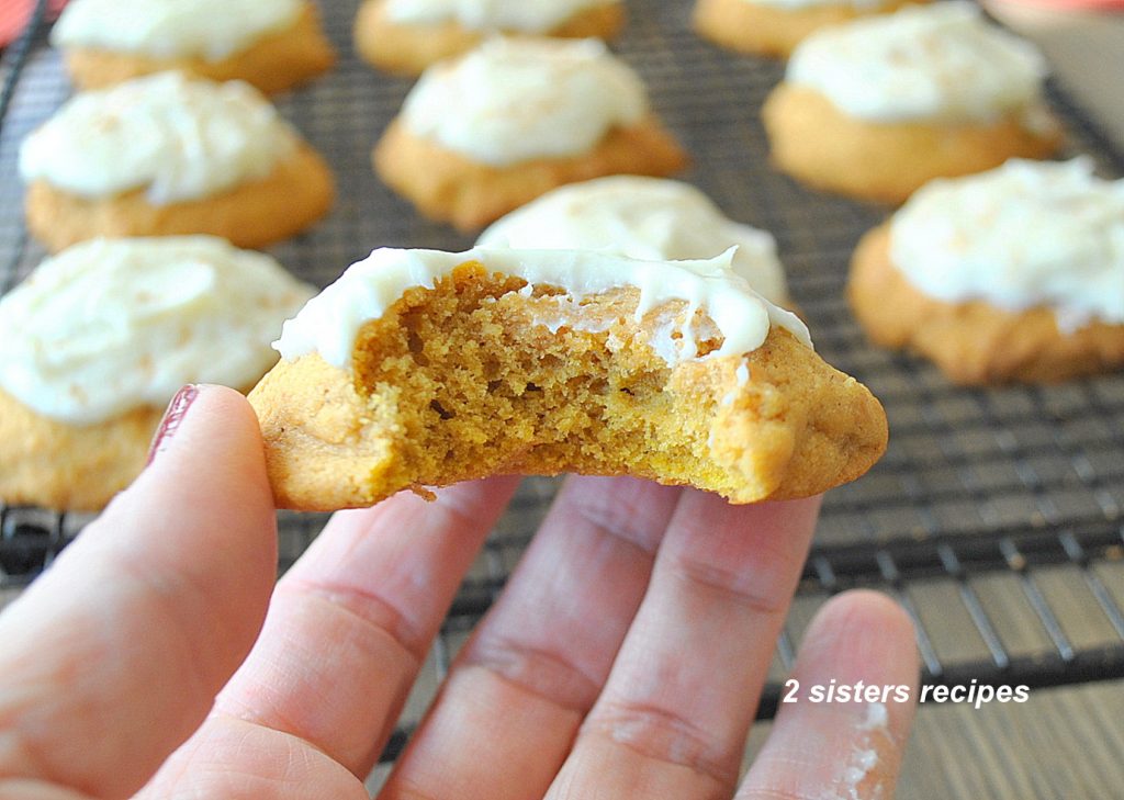 A bite taken out of a pumpkin cookie by 2sistersrecipes.com 