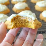 One pumpkin cookie with a bite into it.