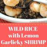 A platter filled with wild rice and cooked shrimp on top.