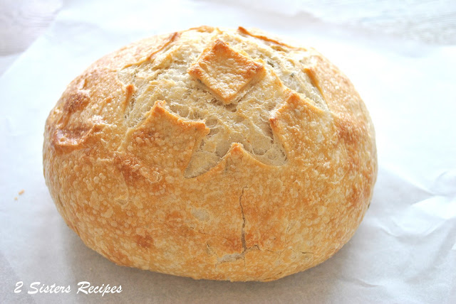 A round loaf of Italian bread by 2sistersrecipes.com