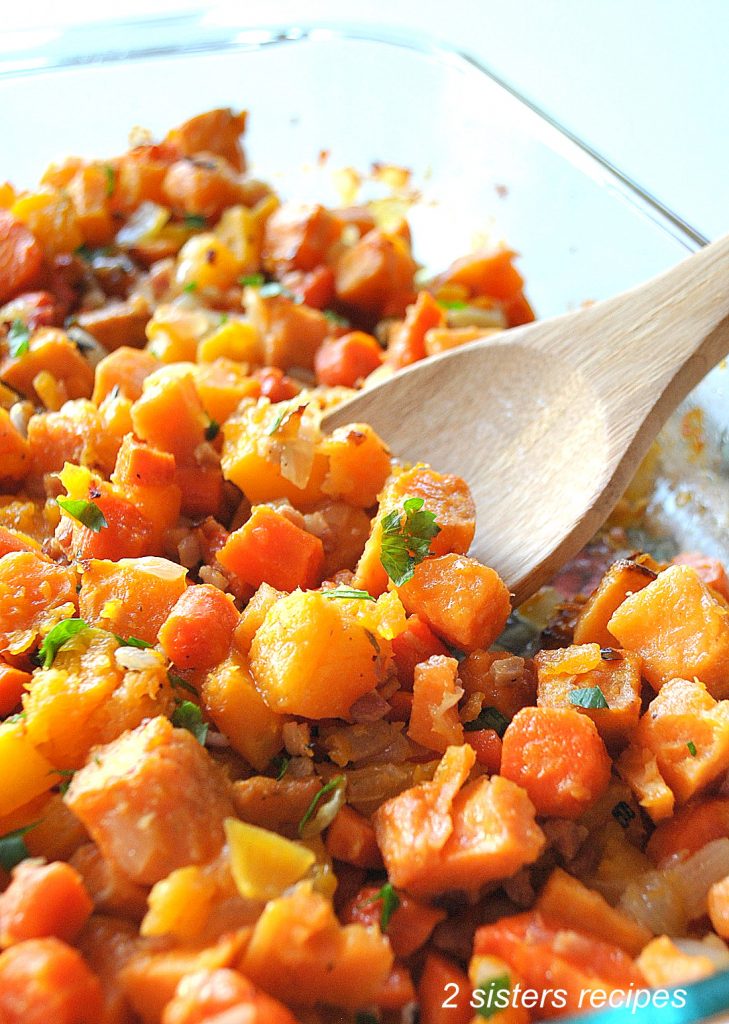 A glass pyrex dish filled with chopped butternut and sweet potatoes.