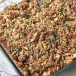 A glass Pyrex dish loaded with an Italian Thanksgiving stuffing.
