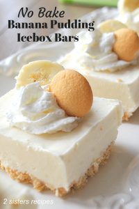 A white platter with a serving of frozen banana icebox bars topped with dollop of whipped cream, a cookie and slice of banana.