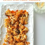 Baked Caulilflower Wings with Buffalo sauce served in a long white platter.