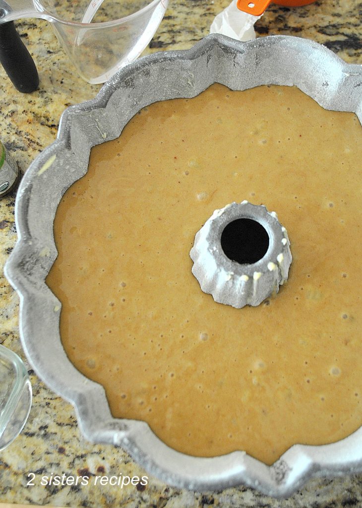 A photo of the cake batter inside the bundt cake pan before it is baked.  by 2sistersrecipes.com