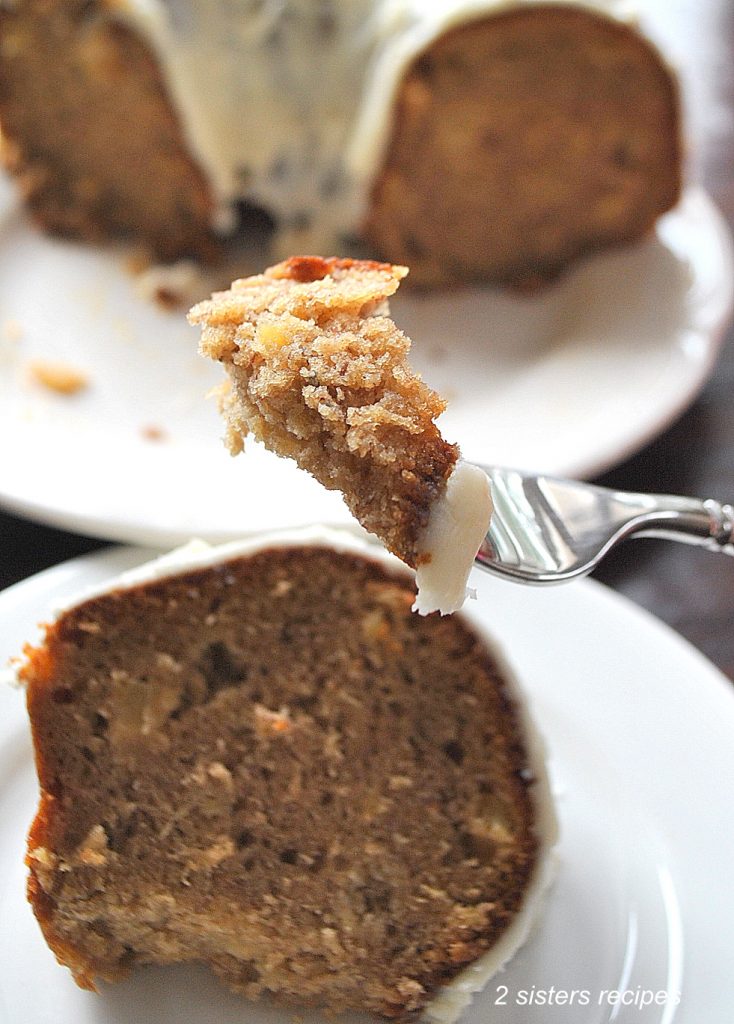 A forful of spice cake with frosting. by 2sistersrecipes.com