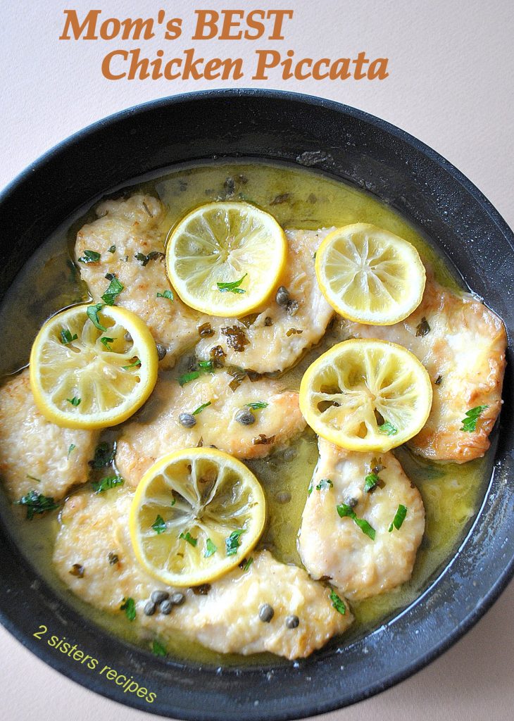 A black skillet filled with cooked chicken piccata