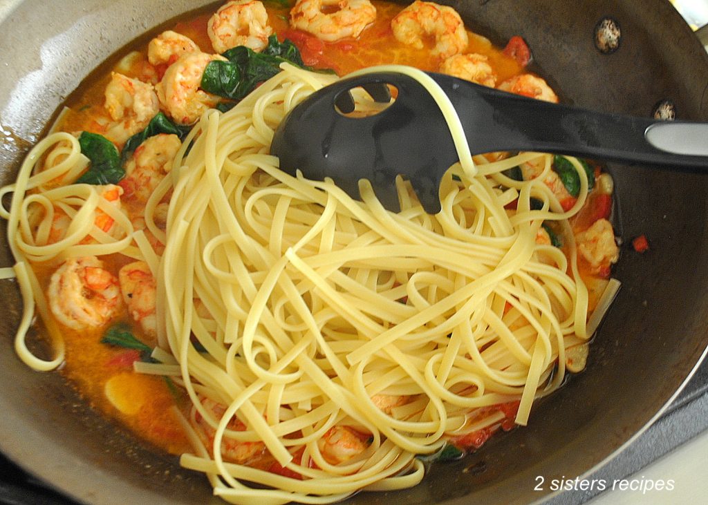 Linguine is added to the shrimp mixture. by 2sistersrecipes.com 